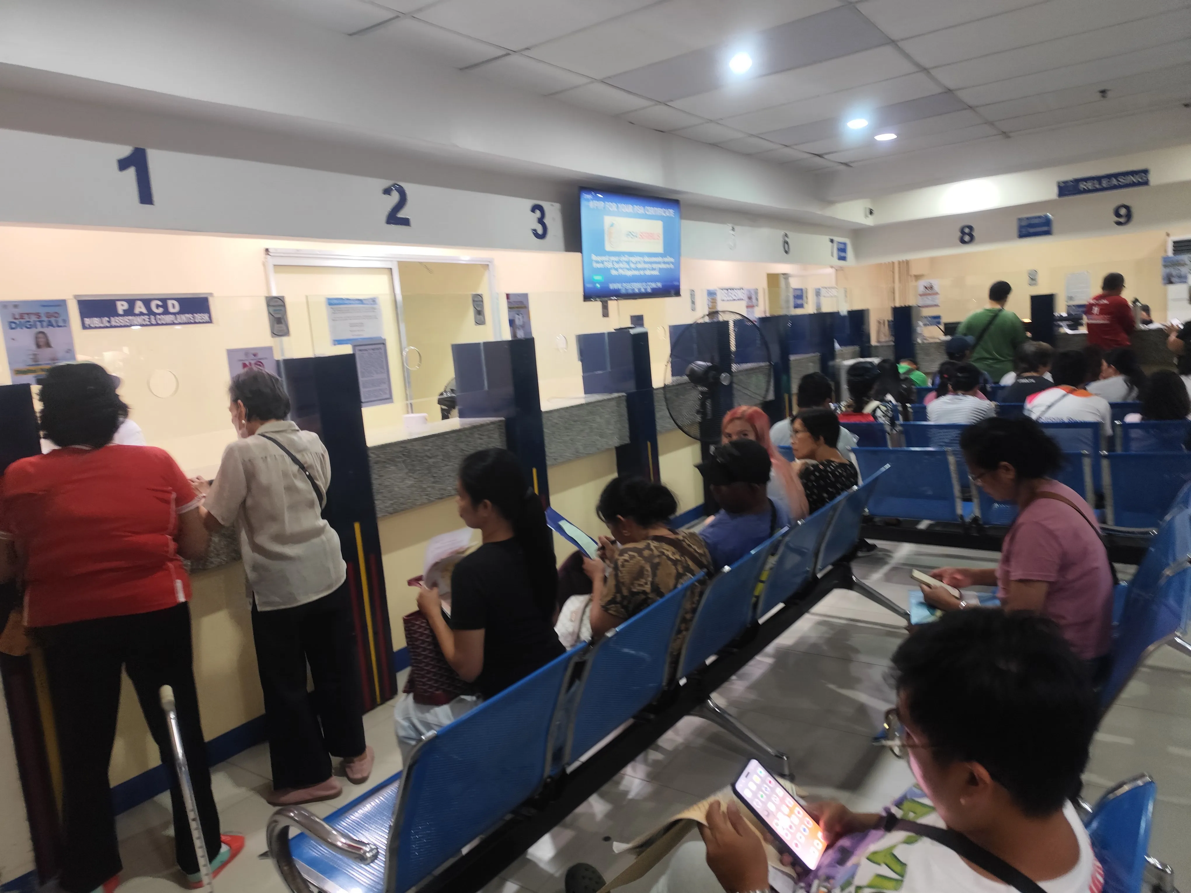 PSA CRS Cebu City Outlet waiting area with blue chairs and numbered counters 1–9