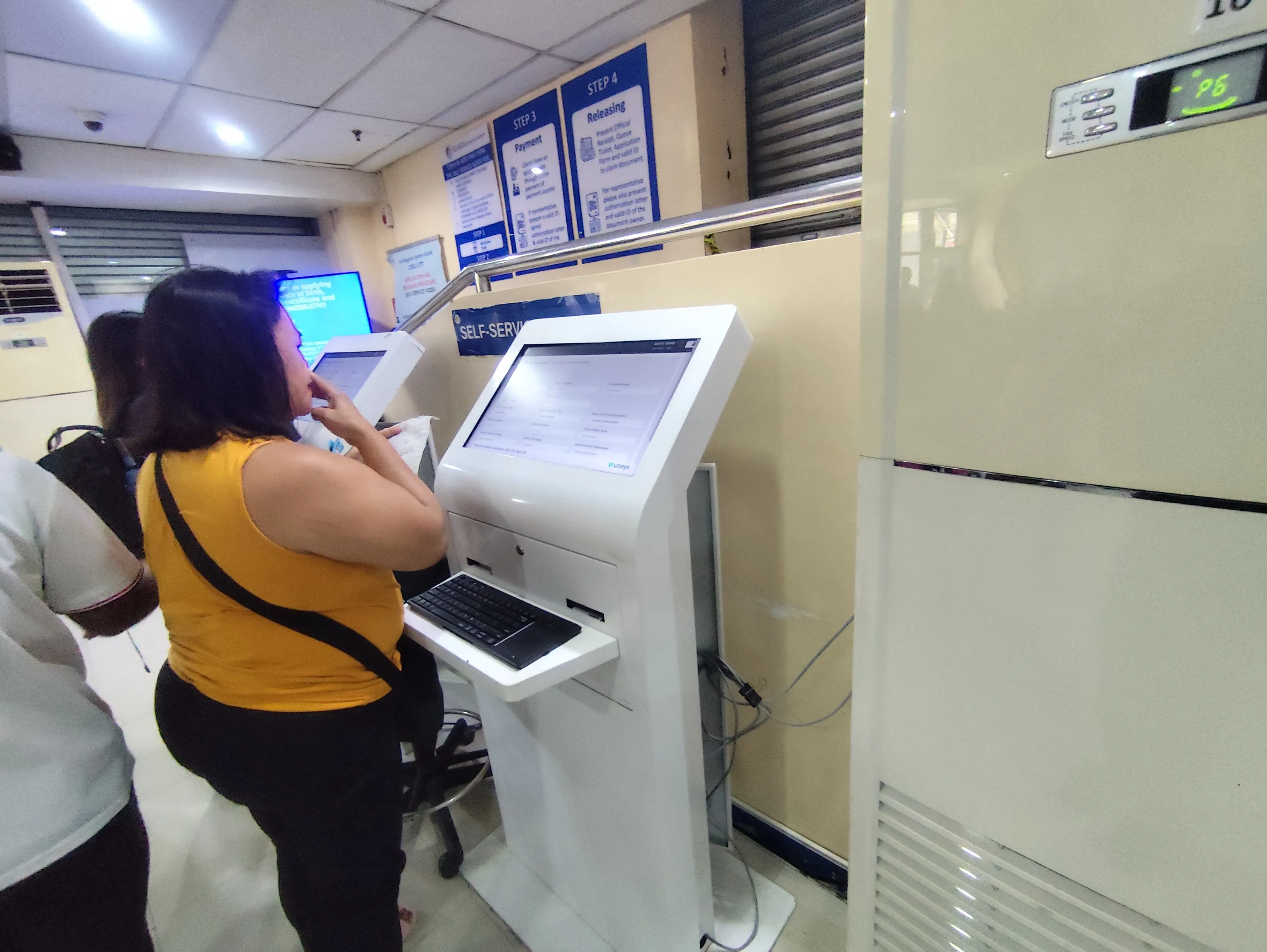 White touch-screen self-service kiosk terminal at PSA CRS