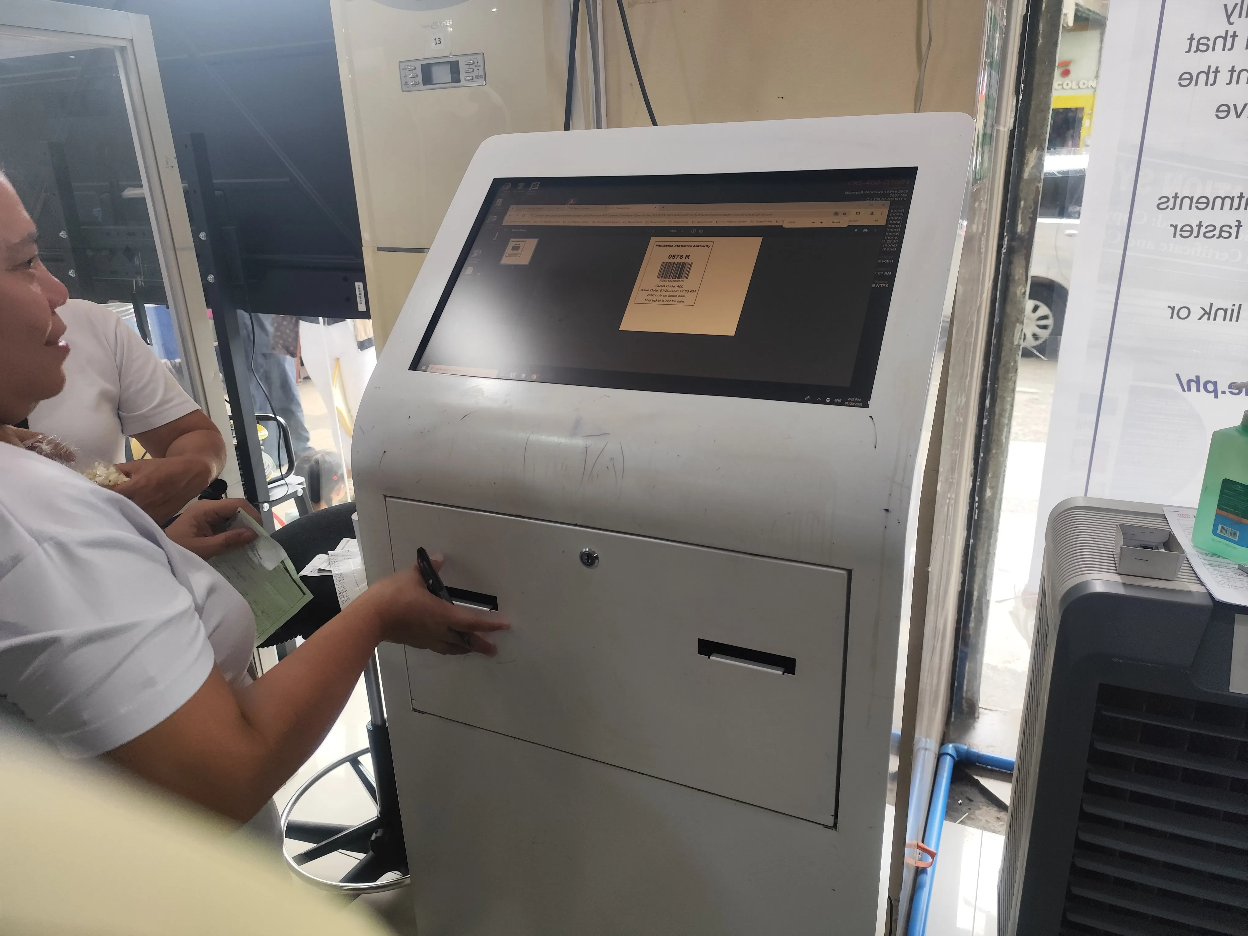 Barcode-printed queue number ticket being issued from the kiosk